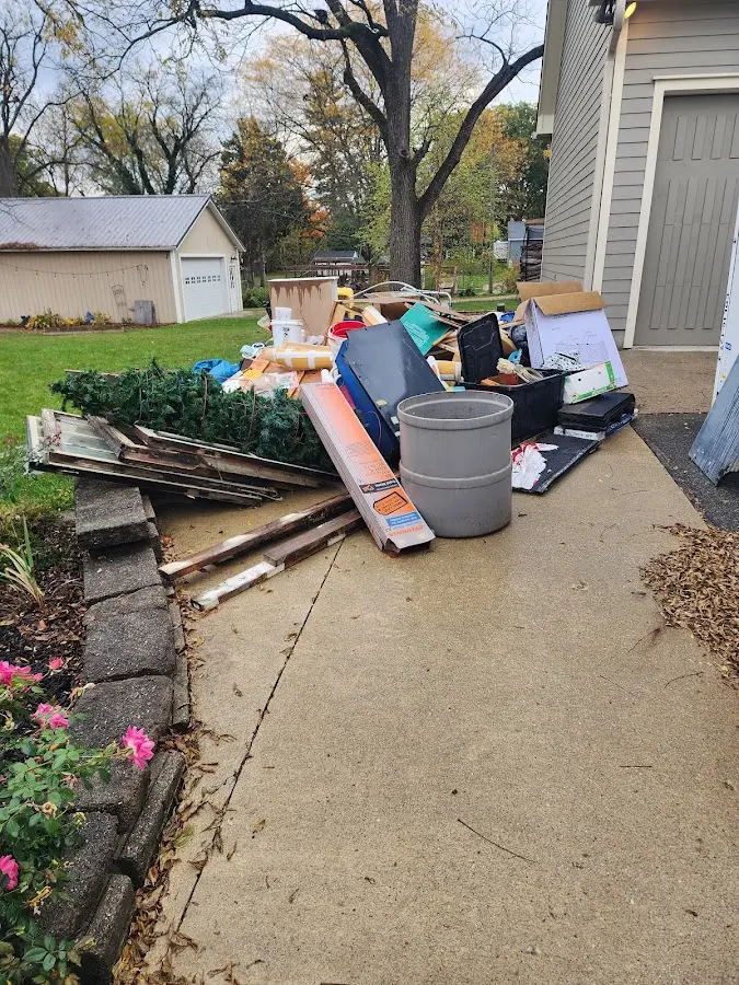 Dumpster being loaded with debris for Roofing Dumpster Rental in New London